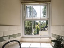 A bathroom with a window showing a garden at Bobbin Nook