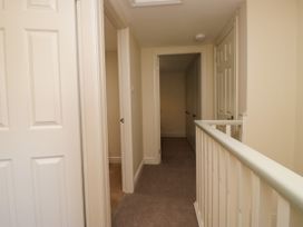 A hallway with doors and carpet at Bobbin Nook