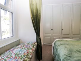 A bedroom with a bed and wardrobe at Bobbin Nook
