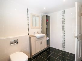 A bathroom with a sink, toilet and mirror at Bobbin Nook