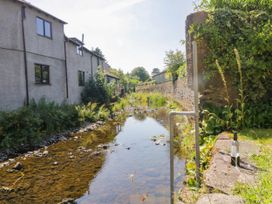 A view of a stream and houses at Bobbin Nook in 