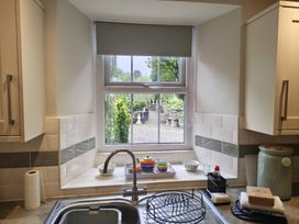 A kitchen with a sink and window overlooking a garden at Bobbin Nook in Staveley