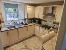 A kitchen with a sink and stove at Bobbin Nook in Staveley