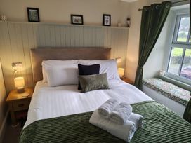 A bedroom with a bed and bedside table at Bobbin Nook in Staveley