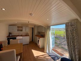 A kitchen with a table and chairs at The Orchard in Ringstead
