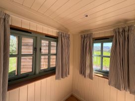 A room with two windows and striped curtains at The Orchard in Ringstead