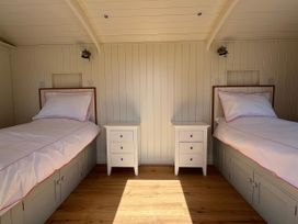 A bedroom with two beds and nightstands at The Orchard in Ringstead