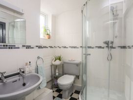 A bathroom with a shower and sink at Ty Gwenno in Criccieth