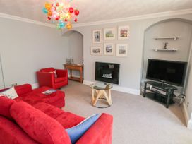 A living room with a television and seating area at The Hideaway in Whitby