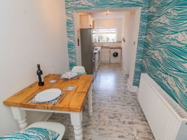 A dining room with a table and chairs at The Hideaway in Whitby