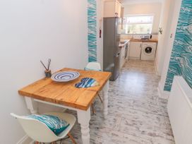 A kitchen with a table and chairs at The Hideaway in Whitby