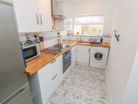 A kitchen with appliances and wooden countertop at The Hideaway in Whitby