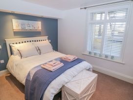 A bedroom with a bed and window at The Hideaway in Whitby