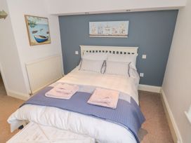 A bedroom with a bed and wall art at The Hideaway in Whitby