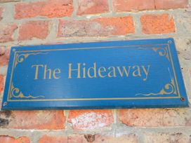 A sign that says The Hideaway on a brick wall at The Hideaway in Whitby