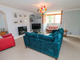 A living room with a sofa and television at The Hideaway in Whitby