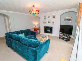A living room with a sofa and television at The Hideaway in Whitby