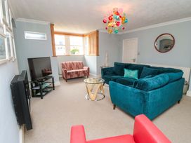 A living room with a television and sofa at The Hideaway in Whitby