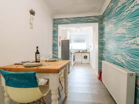 A kitchen with a table and chairs at The Hideaway in Whitby