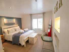 A bedroom with a bed and window at The Hideaway in Whitby