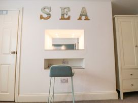 A bedroom with a desk and stool at The Hideaway in Whitby