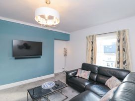 A living room with a sofa and television at Cuckoo's Nest in Whitby