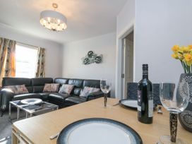 A living room with a sofa and dining table at Cuckoo's Nest in Whitby