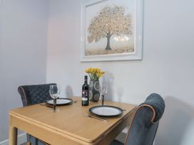 A dining room with a table set for two at Cuckoo's Nest in Whitby