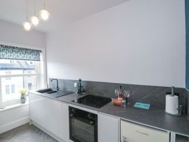 A kitchen with a sink, stove, and fridge at Cuckoo's Nest in Whitby