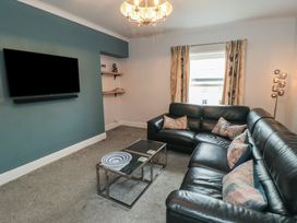 A living room with a sofa and TV at Cuckoo's Nest in Whitby