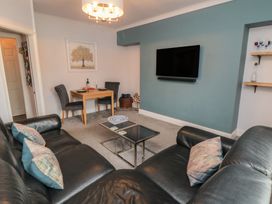 A living room with a sofa and dining table at Cuckoo's Nest in Whitby