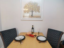 A dining room with a table set for two at Cuckoo's Nest in Whitby