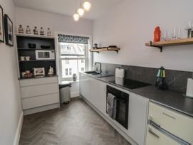 A kitchen with cabinets, a sink, oven, and appliances at Cuckoo's Nest in Whitby