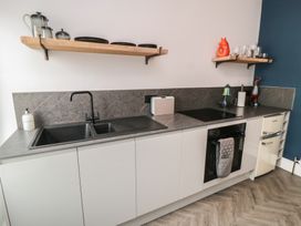 A kitchen with sink, oven, and countertop at Cuckoo's Nest in Whitby