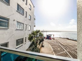A view of a building and sea from a window at Flat 17 Golden Gates in Poole