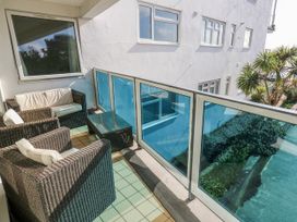 A balcony with seating and a table at Flat 17 Golden Gates in Poole