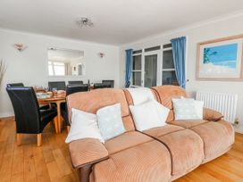 A dining room with a sofa and a dining table at Flat 17 Golden Gates in Poole