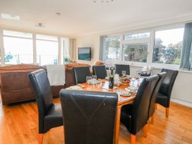 A dining room with a table set for a meal at Flat 17 Golden Gates in Poole