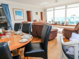 A dining room with a table set and seating area at Flat 17 Golden Gates in Poole