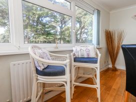 A sitting room with chairs and a window at Flat 17 Golden Gates in Poole