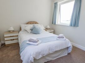 A bedroom with a bed and bedside table at Flat 17 Golden Gates in Poole