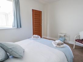 A bedroom with a bed and towels at Flat 17 Golden Gates in Poole