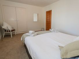 A bedroom with a bed and towels on it at Flat 17 Golden Gates in Poole