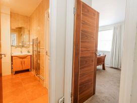 A bathroom with a sink and mirror at Flat 17 Golden Gates in Poole