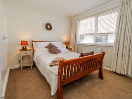 A bedroom with a bed and bedside table at Flat 17 Golden Gates in Poole