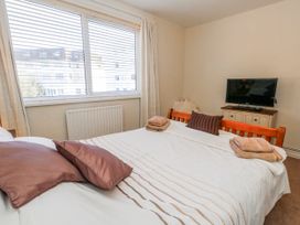 A bedroom with a bed and a television at Flat 17 Golden Gates in Poole