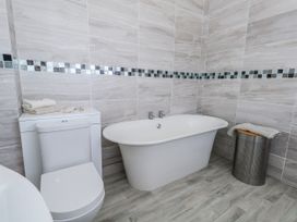A bathroom with a toilet and a bathtub at Flat 17 Golden Gates in Poole
