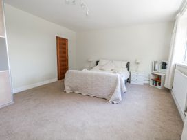 A bedroom with a bed and nightstands at Flat 17 Golden Gates in Poole