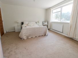 A bedroom with a bed and nightstand at Flat 17 Golden Gates in Poole