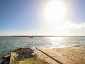 A view of a pier over water with a boat at Flat 17 Golden Gates in Poole